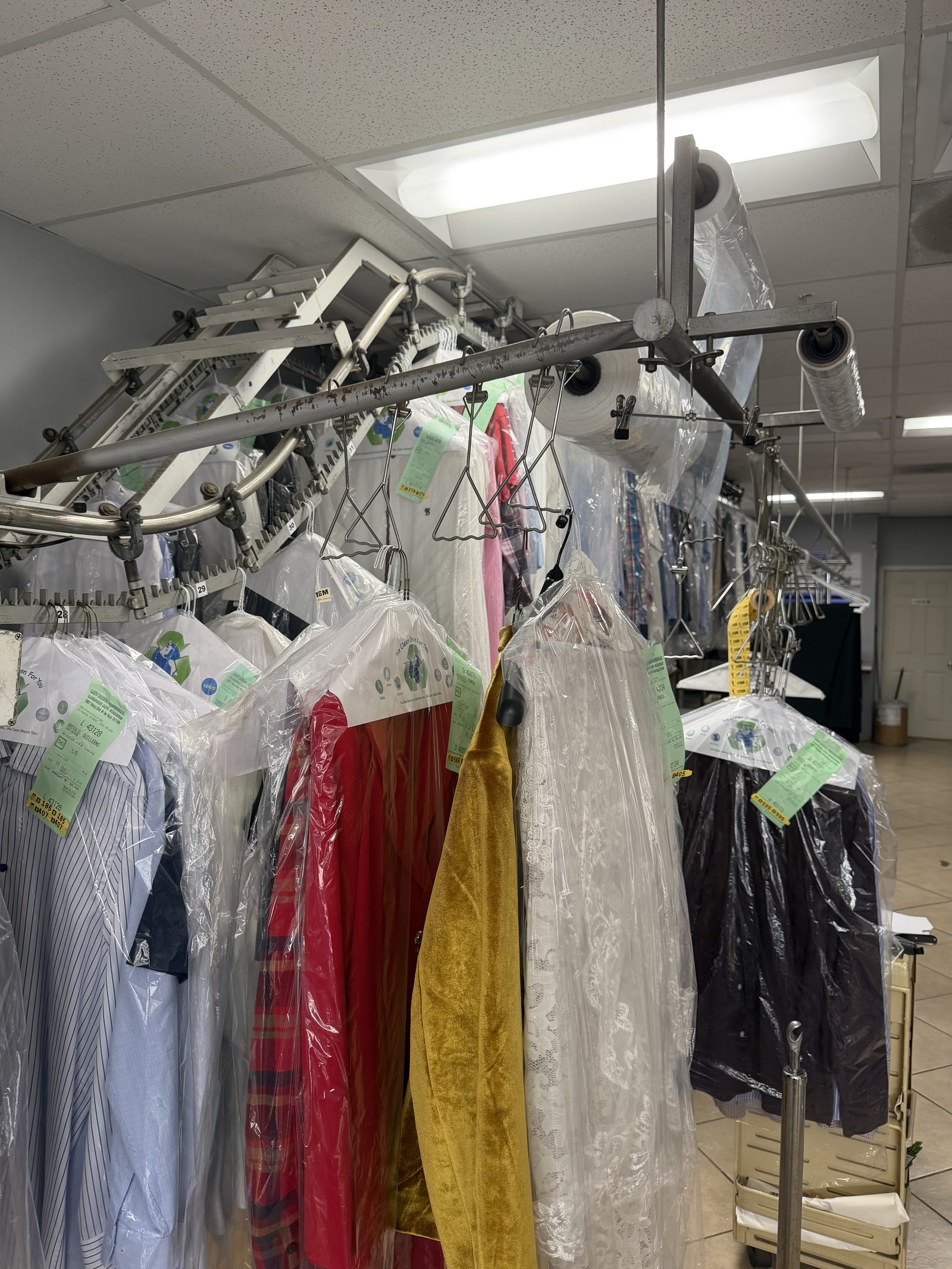 FOLD's overhead Saratoga conveyor rack with finished dry-cleaned garments — owned LA facility