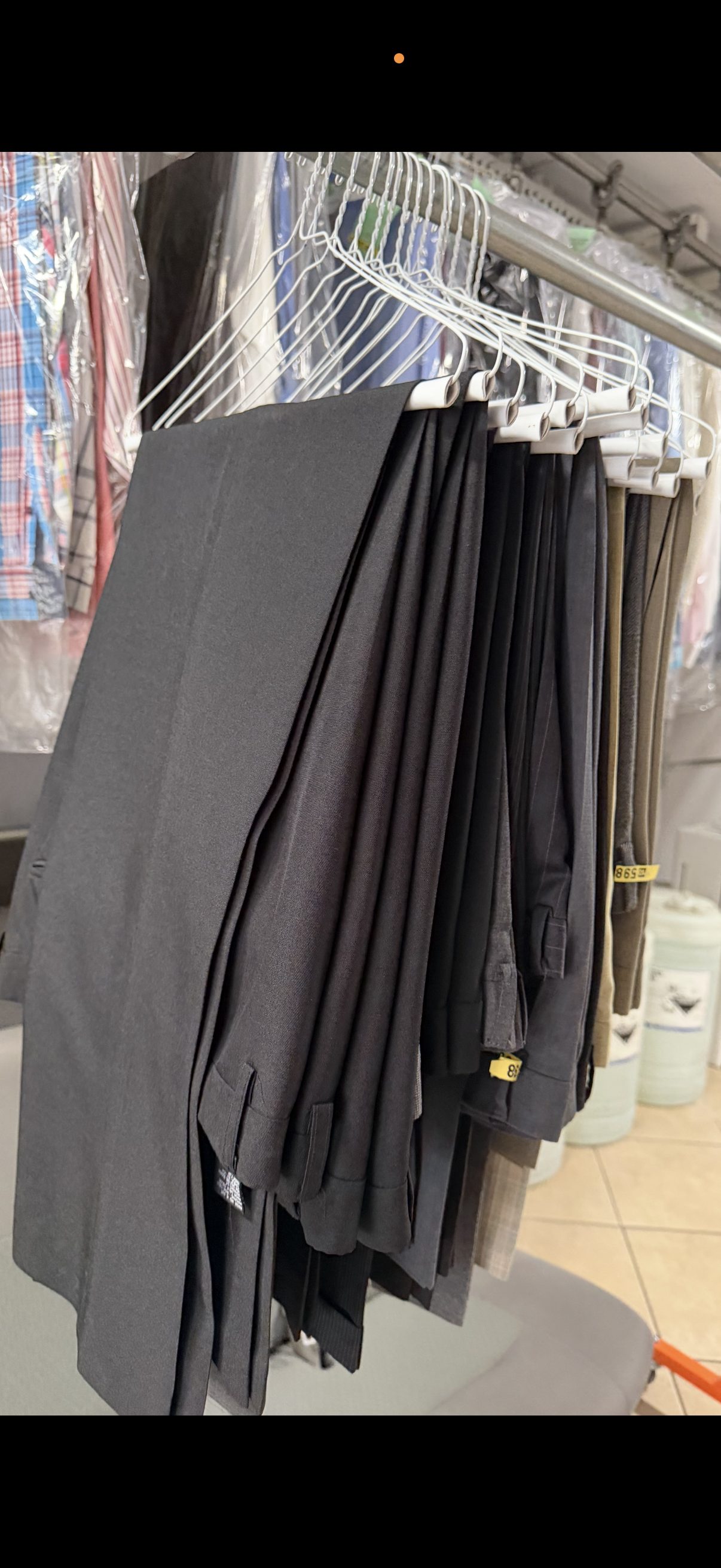 FOLD hand-finish pants on hangers — pressed, hung, ready for delivery